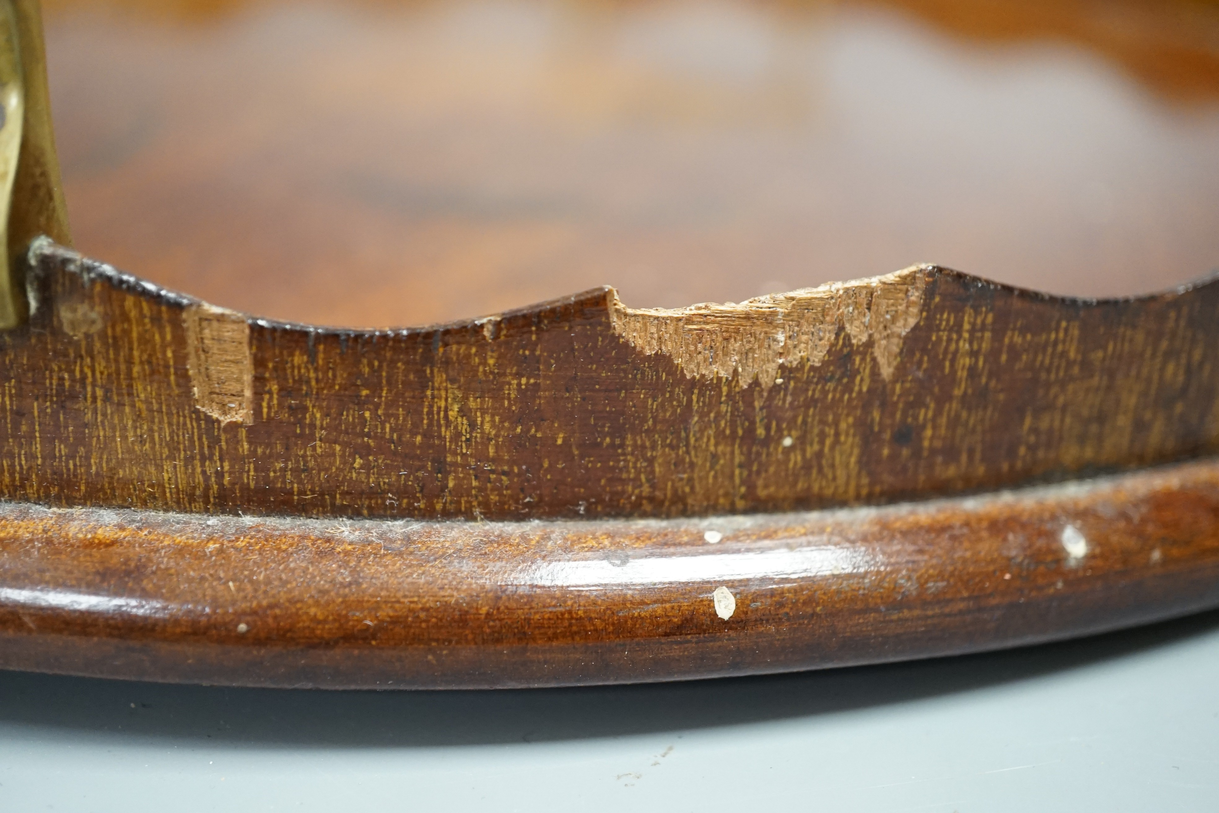 A circular shell inlaid, pie crust edged, brass handled, mahogany tray, 34.5 cms diameter